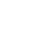 Two people standing at a round table, facing each other, with scissors hanging from the table's center.